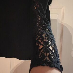 Cut black sweater brand knitted and knotted